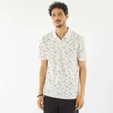 Remera polo blanca de piqué de algodón con estampado de palmeras y tablas de surf.