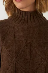 Sweater de lana color crudo, tejido de punto industrial con cuello medio.