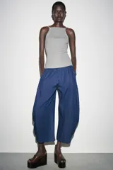 Top plateado de punto con cuello halter y tirantes finos.