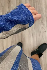Vestido de punto tejido en tonos azul y plateado, con diseño de rayas y corte oversize.