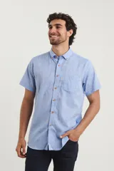 Camisa celeste de manga corta con cuello abotonado y bolsillo en el pecho.