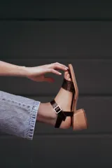 Sandalias negras de cuero con textura de cocodrilo, taco foliado en madera de 6cm y hebilla plateada.