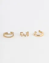 Set de tres cuffs dorados de metal con diferentes diseños: uno doble trenzado, uno liso y uno con hojas.