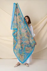 Pañuelo cuadrado de seda estampada con motivos de arabescos en tonos celeste, amarillo, rosa y verde.