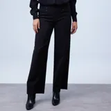 Pantalón de vestir negro de tiro alto, corte wide leg y pierna ancha. Presenta detalles de botones decorativos en la parte frontal superior y bolsillos laterales.