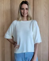 Buzo de punto color verde kiwi con cuello, puños y ruedo en azul.