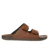 Sandalias tipo birkenstock de dos tiras ajustables, color marrón cuero desgastado, con suela marrón oscura. La marca REEF está grabada en el lateral de la base.
