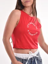 Musculosa gris con estampado de una escena de playa con una palmera y el texto "Sunshine Surf".
