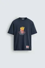Camiseta azul marino de corte relaxed fit, cuello redondo y manga corta. Presenta un estampado de un plato de papas fritas con texto en el frente y un parche con logo en el ruedo.