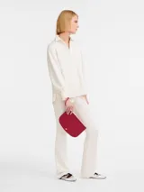 Clutch de cuero con muñequera, diseño elegante y minimalista, ideal para completar cualquier look.