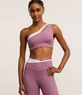 Top deportivo de microfibra color lila con detalle bicolor blanco, hombro único, escote asimétrico y gota vazada.