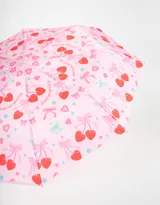 Paraguas corto plegable color rosa con estampado de cerezas, moños y estrellas.