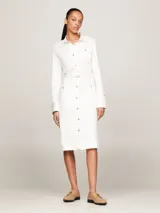 Vestido camisero midi color blanco, de corte recto, con cuello camisero, manga larga, cinturón con hebilla y múltiples bolsillos.