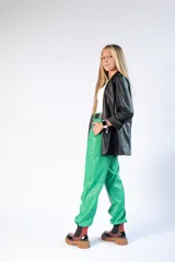 Pantalón engomado color verde, con corte relajado y cintura alta.