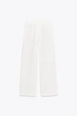 Pantalón culotte color blanco confeccionado en mezcla de lino, con bolsillos laterales, pinzas y raya planchada en delantero.