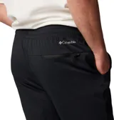 Pantalón de jogging negro con logo de Columbia en blanco en el muslo.