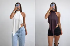 Top negro con cuello alto, escote halter y diseño asimétrico con un lado más largo que el otro.