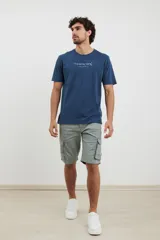 Remera azul oscuro de corte recto y manga corta, con estampado frontal de texto en color gris.