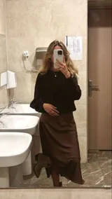 Pollera midi marrón de seda, con cintura elástica.