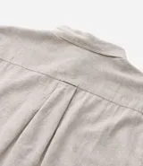 Camisa de hombre de manga corta color arena, confeccionada en lino y algodón. Tiene cuello camisero, corte clásico, cierre frontal con botones, un bolsillo en el pecho y ruedo recto.