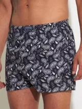 Bóxer de algodón con estampado floral en tonos azul y blanco, con cintura elástica y logo de la marca en el centro.