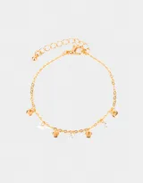 Pulsera dorada flexible con dijes circulares y de circonia cúbica transparente.