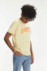 Remera Levi's color amarillo claro con estampado de la palabra "California" en degradé de naranja a rojo y logo de Levi Strauss & Co.