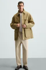 Pantalón verde militar de corte carrot fit, confeccionado en tejido de algodón. Cuenta con cintura elástica ajustable con cordón, bolsillos frontales y un bolsillo trasero de plastrón.