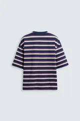 Camiseta de hombre a rayas horizontales azul marino, blancas y rojas, de corte holgado, cuello redondo y mangas cortas.