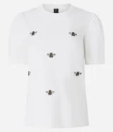 Blusa blanca de algodón con cuello redondo, mangas cortas abullonadas y bordados de abejas.