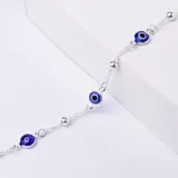 Pulsera de plata 925 con dijes de ojo turco azul y bolitas plateadas.