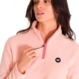 Buzo polar de mujer Caterpillar color blanco, con cierre parcial con cremallera verde y logo de la marca en el pecho. Cuenta con bolsillos laterales.