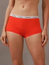 Bombacha hípster color naranja de algodón elástico, con cintura elástica blanca con logo Calvin Klein.