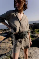 Faja ancha de cuero con hebilla metálica y detalle de bolsillo.