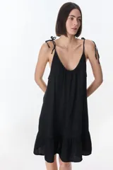 Vestido corto celeste con breteles finos y volados en el ruedo.