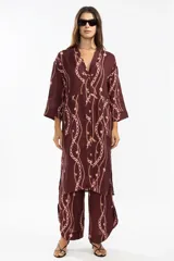 Camisa larga de lino italiano color borgoña con estampado de cadenas rosas. Tiene corte estilo japonés, tres botones delanteros y mangas 3/4.