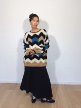 Sweater tejido a mano con lana merino, multicolor con patrón de zigzag en blanco, negro, rojo y beige.