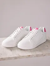 Championes blancos de cuero sintético con detalles en rosa en el talón y la lengüeta. Cordones blancos y suela blanca de goma.