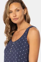 Musculosa azul con estampado de formas geométricas en blanco, escote redondo y botones decorativos en el frente.