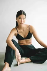 Top de bikini negro, de corte triangular clásico, con tirantes finos y copas removibles.