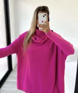 Sweater fucsia de tejido de punto, corte amplio, mangas largas y cuello alto con caída.