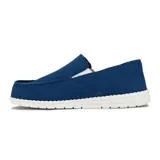 Zapato casual de hombre tipo slip-on, color azul marino, con elásticos laterales y suela blanca.