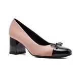 Zapato de cuero color nude con puntera y taco bloque en charol negro. Presenta un pequeño moño decorativo en la puntera.