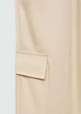 Pantalón color beige de corte recto y largo, con cintura elástica, bolsillos laterales y traseros, y bolsillos cargo en los laterales.