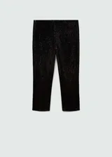 Calza capri negra cubierta de lentejuelas, con cintura elástica y corte skinny.