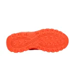 Championes Lotto de mujer color naranja con detalles en blanco, ideales para hockey.