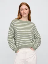Sweater de punto color verde claro con rayas horizontales blancas, de corte holgado y cuello redondo.