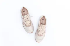 Zapatillas Magnolia plateadas con detalles en blanco y suela marrón.