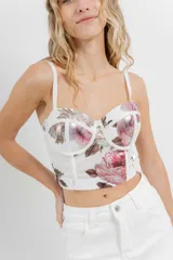 Top tipo corset con estampa floral, confeccionado en tul elástico con estructura interna y copas armadas. Breteles regulables y cierre con triple hilera de broches en espalda.