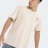 Remera color beige de corte oversize, con logo de Reef estampado en el pecho.